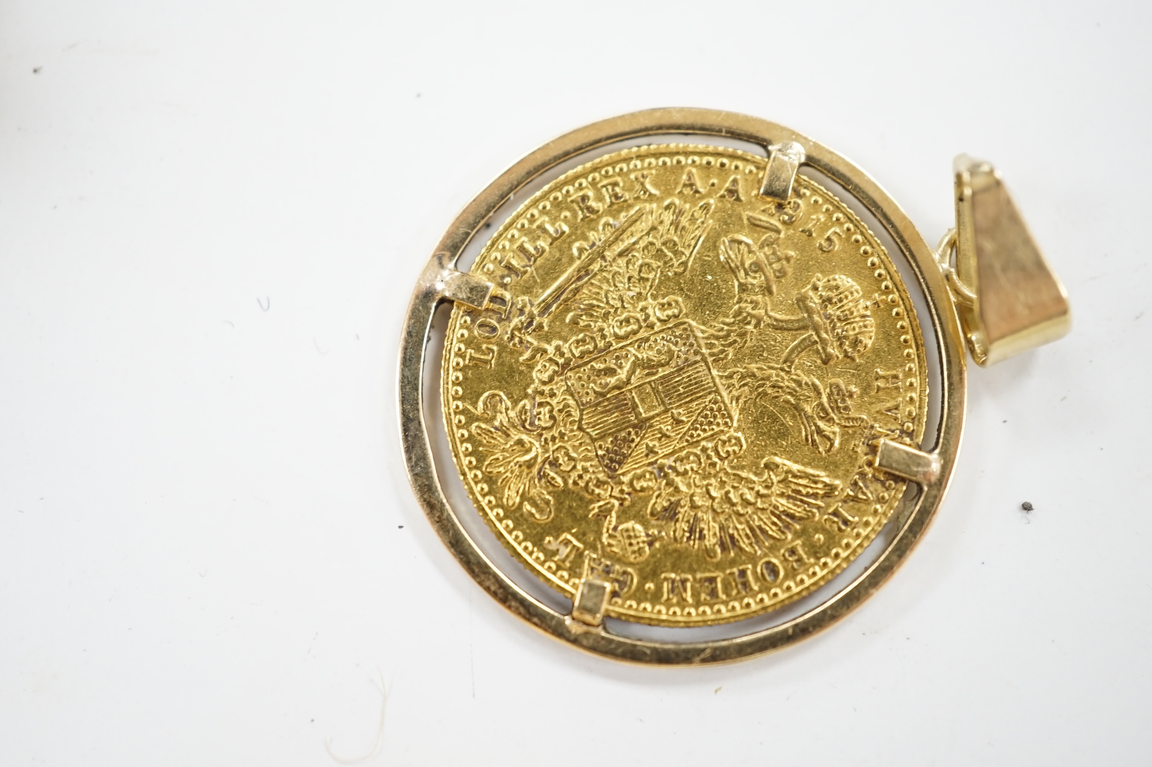 A 1915 gold coin in pendant mount, a pair of two stone cabochon garnet set drop earrings, 22mm, three yellow metal rings and a 9ct and gem set clasp. Condition - poor to fair